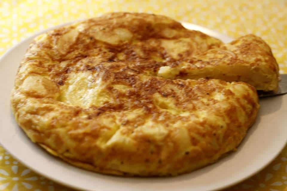 cooked Spanish tortilla with a slice taken out